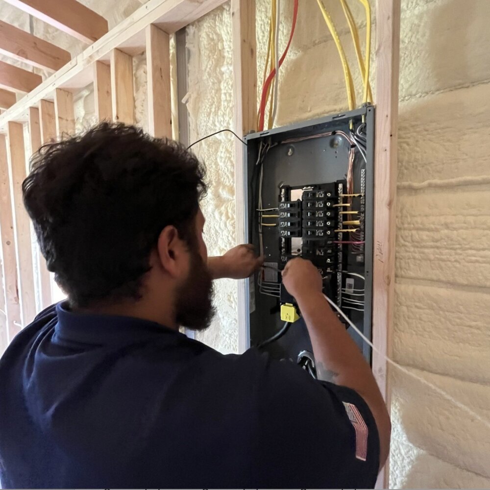 LiveWire electrician working in an electrical panel